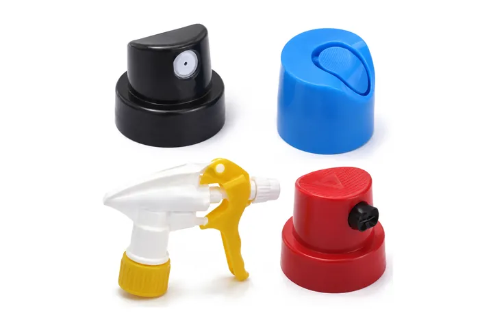 Plastic spray caps and a trigger sprayer in black, blue, red and white