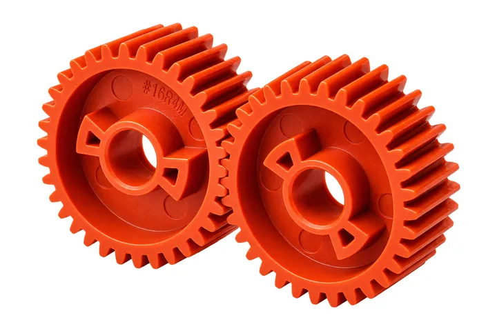 Pair of orange molded plastic spur gears